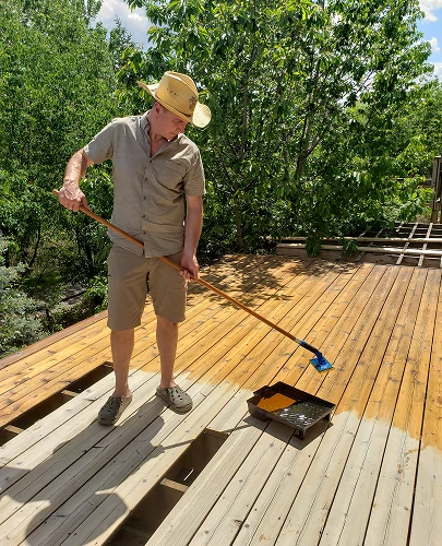 adult-man-staining-wooden-deck-on-sunny-day-2026-03-17-08-58-03-utc 1